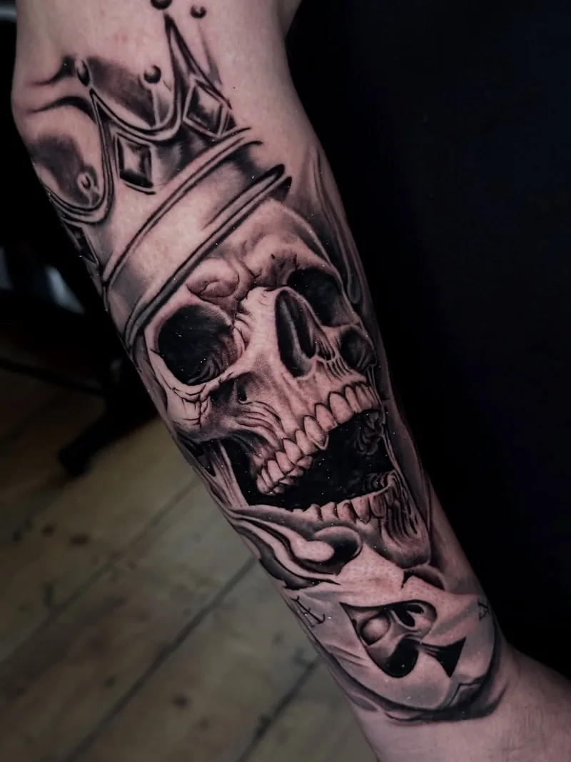 a crowned skull on the forearm, black and grey realism tattoo by Lucas Zatti, Temple Bar Dublin