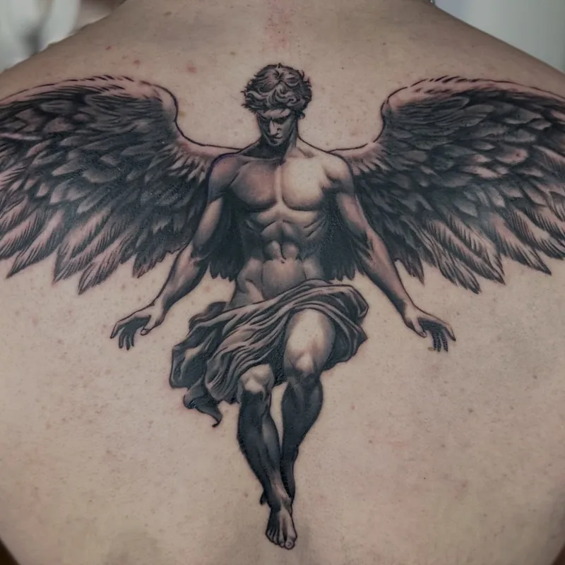 a winged angel across the upper back, black and grey realism tattoo by Lucas Zatti, Temple Bar Dublin